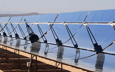 SEGS solar thermal energy electricity plant with parabolic mirrors concentrating the sunlight