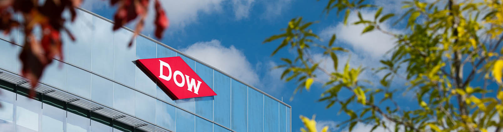 Dow Diamond sign through trees on the Global Dow Center in Midland, Michigan 