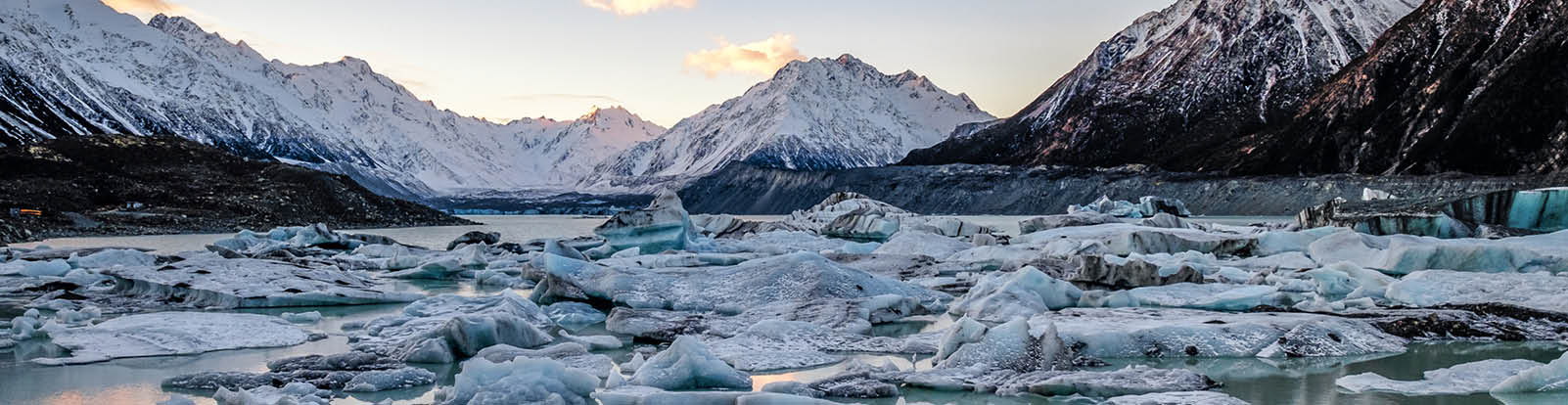 Snowy mountains and water with icebergs in New Zealand