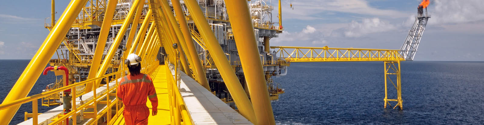 Operator walking operation of oil and gas process at oil and rig plant 