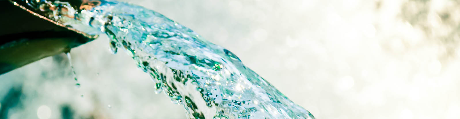 Close up of water gushing out of a pipe