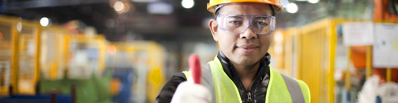 Portrait asian engineer showing thumb up in factory