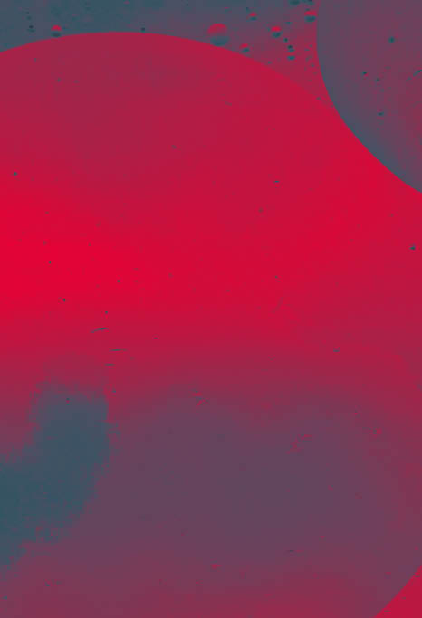 Close up macro image depicting droplets of oil in water on a multi colored background  The oil forms interesting circles and spheres in the water, and colorful background produces and abstract effect  Horizontal color image with copy space 