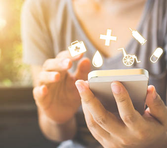 Hand of woman using mobile phone She is deciding to make health insurance
