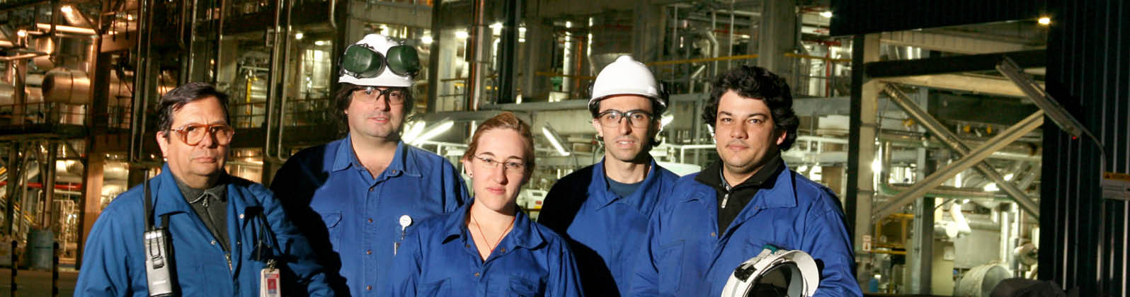 Bahia Blanca employees in Protection Equipment outside the plant at night